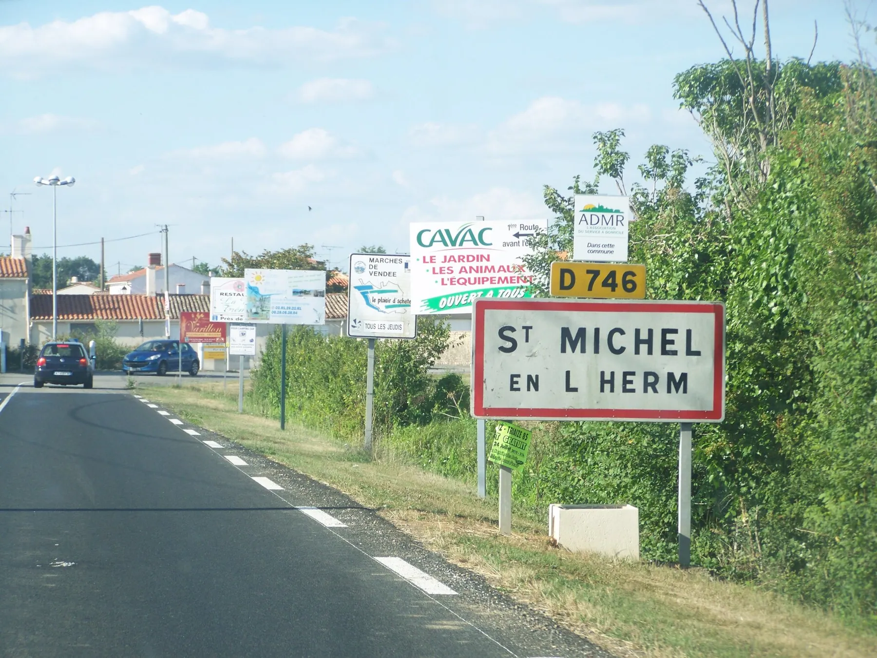 Sign welcoming visitors to the village of St-Michel en l'Herm in Vendée, France.